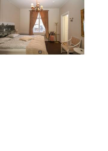 a bedroom with two beds and a window at m i g l i o r e in Pargas