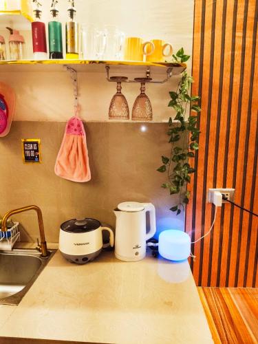 a kitchen counter with two toasters and a sink at Ciel's Deluxe Haven in Binangonan