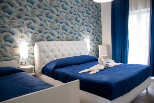 a bedroom with two beds with a stuffed animal on the bed at B & B Victoria in Pompei