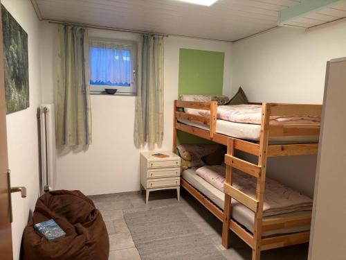 a bedroom with two bunk beds and a window at Ferienwohnung Waldliebe in Waldkirchen