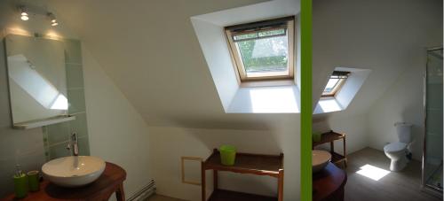 a bathroom with a sink and a toilet and a window at Jardin Solstice in Vaupillon