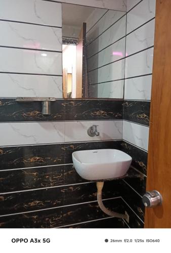 a bathroom with a sink and a mirror at Hotel Vinayak Naroda in Ahmedabad