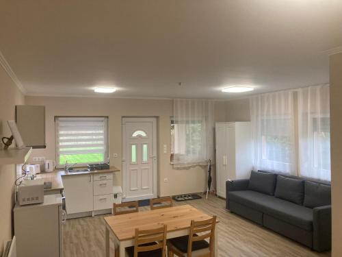 a living room with a couch and a table at Dunaparti Kuckó in Kiskunlacháza