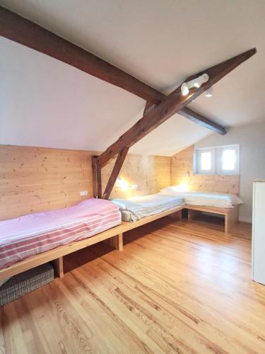 a room with two beds in a attic at Villa Clair Matin in Ax-les-Thermes