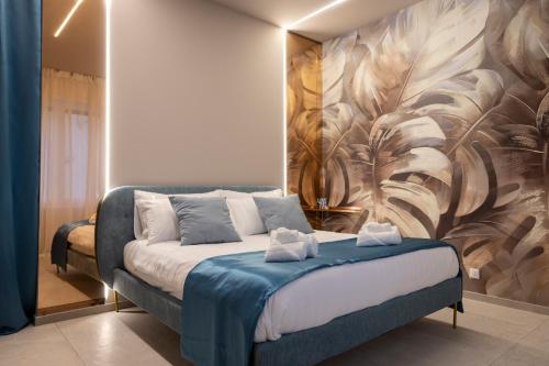 a bedroom with a bed with a painting on the wall at AlexandraDesignSuite -Eleganza vicino al centro in Carpi