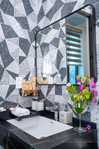 a bathroom with a sink and a mirror at New Sky Light Villa in Dong Hoi