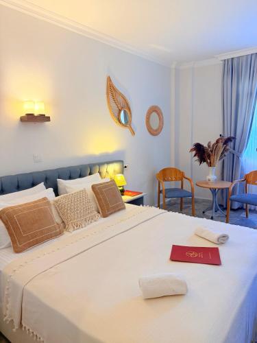 a bedroom with a large bed with a red card on it at Hanedan Beach Hotel in Foça