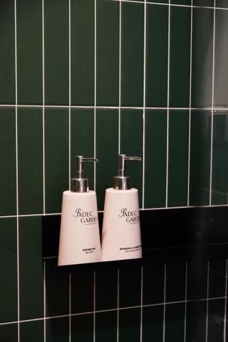 two bottles ofodorizers sitting on a shelf in a bathroom at Sadec Garden Boutique Hotel in Ấp Tân Thành (2)