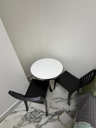 a white table and two black chairs in a room at suites ejecutivas centro guadalupe in Monterrey
