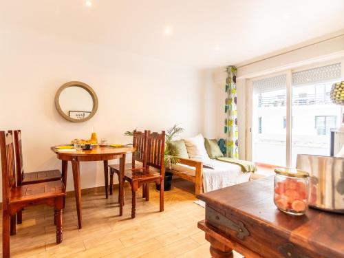 a living room with a table and a couch at Apartment in Oeiras Near Beach Easy Access Lisbon Cascais in Oeiras