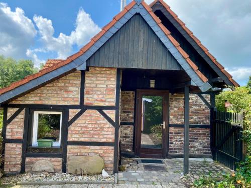 a small brick house with a pitched roof at Zum Schafstall in Hünxe