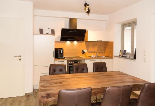 a kitchen with a large wooden table and chairs at Apartment Yachthafen Waren in Waren