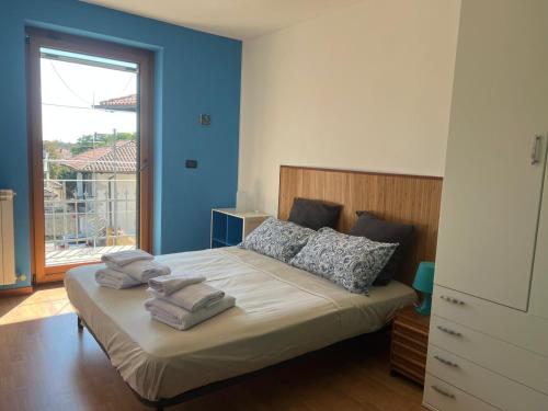 a bedroom with a bed with towels on it at Serenissima in Monfalcone
