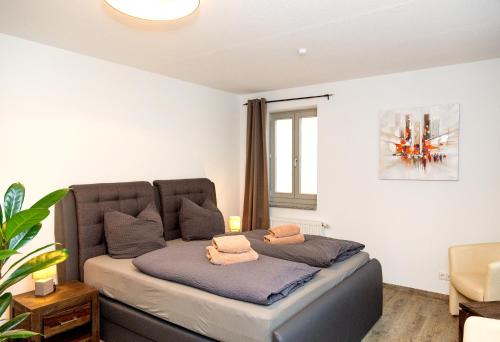 a bedroom with a bed with two towels on it at Apartment Yachthafen Waren in Waren
