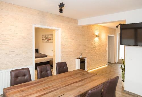 a dining room with a table and chairs and a bedroom at Apartment Yachthafen Waren in Waren
