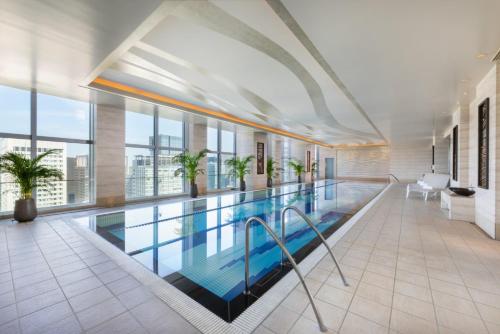 a swimming pool in a large building with windows at Shangri-La Tokyo in Tokyo