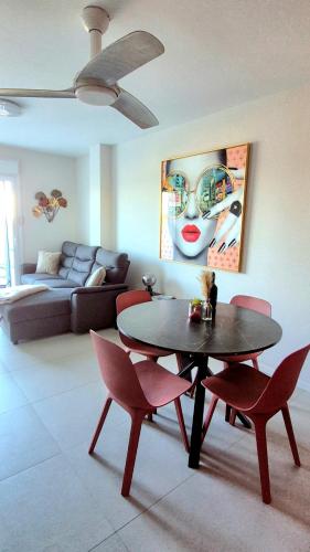 a living room with a table and chairs and a couch at Casa Nina Novastar in San Pedro del Pinatar