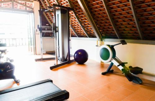 a gym with a treadmill and a ball on the floor at Nipa Resort, Patong Beach - SHA Extra Plus in Patong Beach