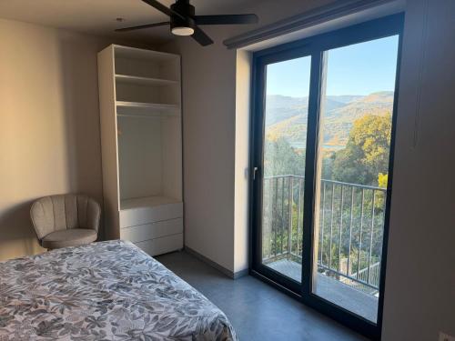 a bedroom with a bed and a balcony with a view at Casa la Perla Solo adultos in Béznar