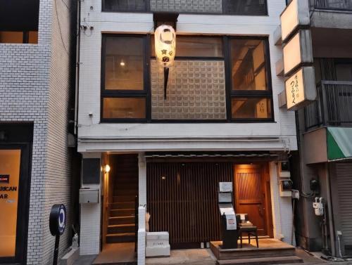 a building with a light on the side of it at Louis House Shibuya in Tokyo