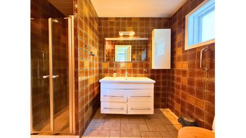 a bathroom with a sink and a shower at 4 Bedrooms Cozy & Spacious Villa - Lalandia & Puttagrden & Femern in Rødby