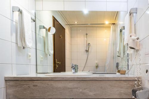 a bathroom with a sink and a shower at Neubichler Alm in Piding