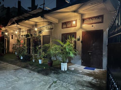 a house with potted plants in front of a door at The Quiet corner 1RK Downtown in Guwahati