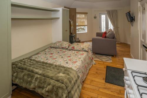 a bedroom with a bed and a couch at Firhurst in Aboyne