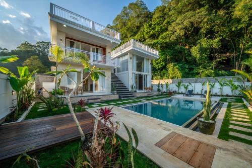 a house with a swimming pool in front of it at Hayana Villa Kintamani in Gretek