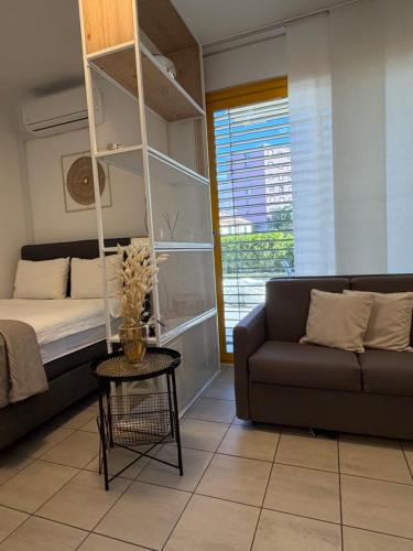 a living room with a bed and a couch at NiceStay in Lugano