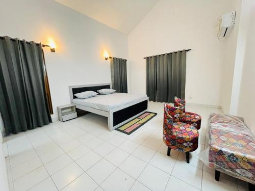 a bedroom with a bed and a chair in it at Traditional villa in Gurgaon