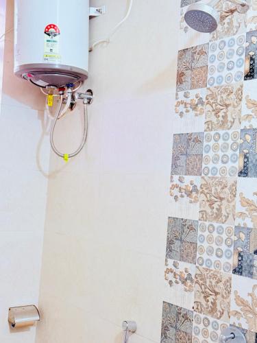 a shower in a bathroom with tiles on the wall at Airport Sky Transit Suites in Rānchī