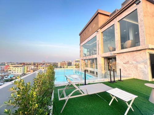 a house with a yard with a swimming pool at Marquis Hotel in Ban Bang Toei (1)