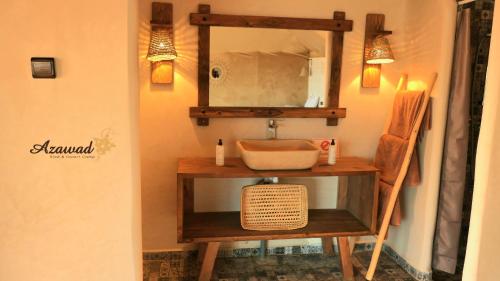 a bathroom with a sink and a mirror at Azawad Desert Luxury Camp in Merzouga
