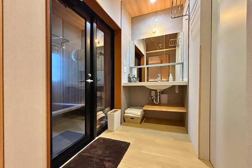 a room with a walk in closet with a glass door at Hotel Teiregikan in Tobe