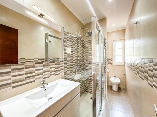 a bathroom with a sink and a toilet at Apartamento Brisa by ALÔGA in Corcubión