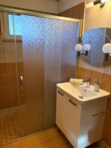 a bathroom with a shower and a sink and a mirror at Penzion Borováček in Borová Lada