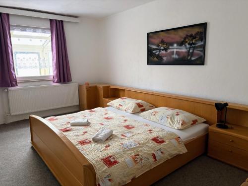 a bedroom with a bed and a window at Penzion Borováček in Borová Lada