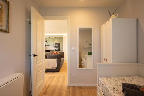 a bedroom with a bed and a living room at A Casiña dos Veiras - 3Km antes de Bruma in Santa Eulalia