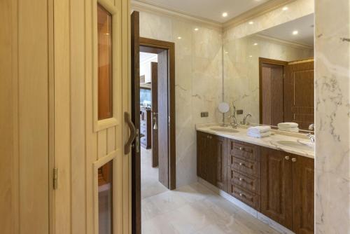 a bathroom with a sink and a mirror at Villa Visanty with Private Pool & Access to Beach in Aigosthena