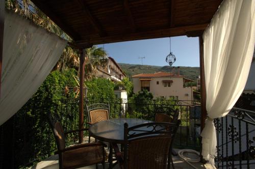 a patio with a table and chairs on a balcony at La Luna in Kala Nera