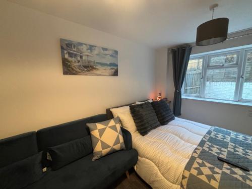 a living room with a bed and a couch at Neptune Nights in Pontnewynydd