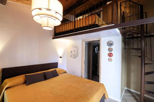 a bedroom with a bed and a spiral staircase at Colosseo Garden Lodge in Rome