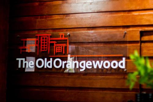 an old orangewood sign on a wooden wall at Old Orangewood Bed & Breakfast in Baguio