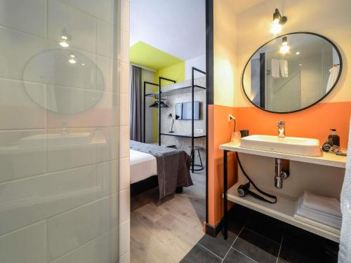 a bathroom with a sink and a mirror at ibis Styles Wien Messe Prater in Vienna