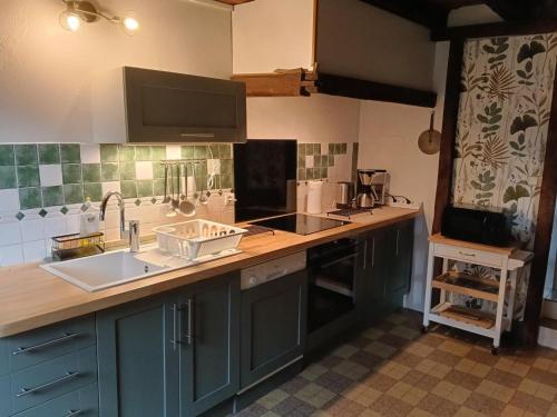 a kitchen with a sink and a counter top at Gîte campagne et clim - 4 pers. - FR-1-489-84 in Saint-Bonnet-Tronçais