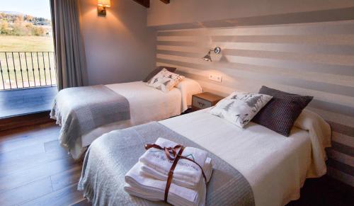 a hotel room with two beds and a window at LES FEIXES LLARGUES - max 18 pax in Bolvir