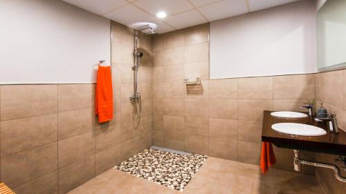 a bathroom with two sinks and a shower at LES FEIXES LLARGUES - max 18 pax in Bolvir