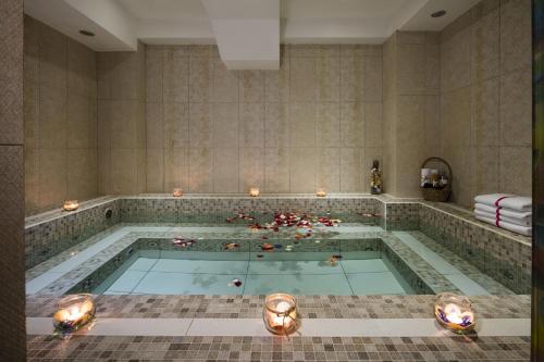 a large swimming pool with candles in it at Paradise Saigon Boutique Hotel & Spa in Ho Chi Minh City