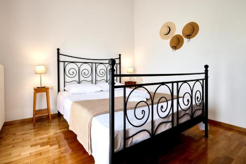 a bedroom with a black bed with a hat on the wall at Zeusplace Lemon Villa in Korinos